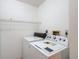Bright laundry room with modern washer and dryer, offering convenience and functionality at 120 Colony South Dr, Tarpon Springs, FL 34689