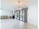 Open living space with vaulted ceiling, fireplace, and sliding glass doors to outdoor patio at 120 Colony South Dr, Tarpon Springs, FL 34689