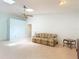 Cozy living room with vaulted ceiling, ceiling fan, and neutral decor at 120 Colony South Dr, Tarpon Springs, FL 34689