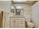 Bathroom features a vanity, mirror, toilet, and a shower with a decorative white curtain at 1221 Drew St # E12, Clearwater, FL 33755