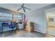 Bedroom featuring laminate flooring, a ceiling fan and adjacent bathroom at 1221 Drew St # E12, Clearwater, FL 33755