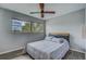 Bedroom with a comfortable bed, ceiling fan, and a window offering natural light at 1221 Drew St # E12, Clearwater, FL 33755