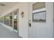 Exterior door with secured lockbox and palm tree door decoration at 1221 Drew St # E12, Clearwater, FL 33755