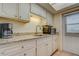 Bright kitchen featuring granite countertops, stainless steel appliances, and white cabinetry at 1221 Drew St # E12, Clearwater, FL 33755