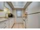 Well-lit kitchen area offering a range, refrigerator and access to the building's exterior at 1221 Drew St # E12, Clearwater, FL 33755