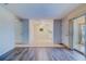 Spacious living area with tile and wood flooring, fan and sliding glass doors to patio at 1221 Drew St # E12, Clearwater, FL 33755