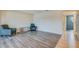 Open living space featuring sleek flooring, neutral walls, and modern glass shelving unit at 1221 Drew St # E12, Clearwater, FL 33755