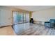 Bright living area with modern flooring, neutral paint, and glass sliding door access to balcony at 1221 Drew St # E12, Clearwater, FL 33755