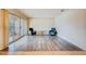Living room with modern wood-look flooring, neutral paint, and sliding glass door to patio at 1221 Drew St # E12, Clearwater, FL 33755