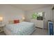 Well-lit bedroom featuring patterned bedding and a six-drawer dresser at 1241 S Martin Luther King Jr Ave # 302, Clearwater, FL 33756