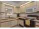 White kitchen with ample counter space and window to living area at 1241 S Martin Luther King Jr Ave # 302, Clearwater, FL 33756