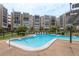 Beautiful community pool with inviting blue water, lounge chairs, and well-maintained landscaping at 1241 S Martin Luther King Jr Ave # 302, Clearwater, FL 33756