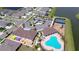 An aerial view showing the community pool, clubhouse, parking, tennis courts, playground, and nearby residences at 12902 Brookside Moss Dr, Riverview, FL 33579