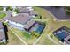 An aerial view of a beautiful home with a screened pool and well-maintained landscaping by the lake at 12902 Brookside Moss Dr, Riverview, FL 33579