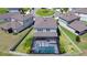 Aerial view of property backyard with pool and screened in patio within a fenced in yard at 12902 Brookside Moss Dr, Riverview, FL 33579