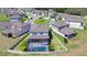 An aerial view of a home with a screened pool surrounded by a white fence in a residential neighborhood at 12902 Brookside Moss Dr, Riverview, FL 33579