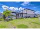 Beautiful backyard with a screened-in pool area, lush landscaping and green lawn at 12902 Brookside Moss Dr, Riverview, FL 33579