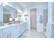 Bright bathroom with a double vanity, white cabinets, and a separate water closet at 12902 Brookside Moss Dr, Riverview, FL 33579