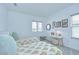 Bedroom with two twin beds, a small writing desk, and neutral decor at 12902 Brookside Moss Dr, Riverview, FL 33579