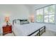 Bedroom featuring a queen bed with decorative pillows and a window with blinds at 12902 Brookside Moss Dr, Riverview, FL 33579