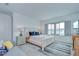 Bright bedroom with a queen bed, neutral decor, large window, and hardwood floors at 12902 Brookside Moss Dr, Riverview, FL 33579