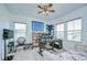 Bedroom featuring a ceiling fan, desk with computer, and workout area at 12902 Brookside Moss Dr, Riverview, FL 33579