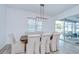 Dining room boasts a rustic wooden table, upholstered chairs, and sliding glass doors leading to the lanai at 12902 Brookside Moss Dr, Riverview, FL 33579