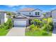 Two story home with beautiful lawn, landscaping, and two car garage in a lakeside community at 12902 Brookside Moss Dr, Riverview, FL 33579