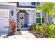 A welcoming front entrance with a glass door, festive wreath, and decorative landscaping at 12902 Brookside Moss Dr, Riverview, FL 33579