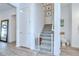 Hallway featuring a staircase, a closed door, and decoratively-framed art ascending up the stairs at 12902 Brookside Moss Dr, Riverview, FL 33579