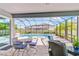 Covered lanai with outdoor seating and a view of the pool and backyard at 12902 Brookside Moss Dr, Riverview, FL 33579