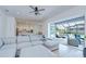 Inviting living room with a sectional sofa and views of the lanai featuring an outdoor dining area and pool at 12902 Brookside Moss Dr, Riverview, FL 33579