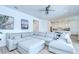 Spacious living room with a large sectional sofa, ceiling fan, and an open view into the kitchen at 12902 Brookside Moss Dr, Riverview, FL 33579