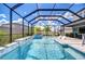 Screened-in pool area with a spa, water feature, and poolside lounge chairs at 12902 Brookside Moss Dr, Riverview, FL 33579
