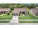 An aerial view of a single-story home, showcasing its neat landscaping and proximity to lush greenery at 13819 Stoneridge Dr, Hudson, FL 34669