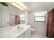 Clean bathroom has an extended vanity, window, and combination tub and shower at 13819 Stoneridge Dr, Hudson, FL 34669