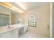 This bathroom features double sinks, lots of vanity counter space, and a walk-in shower at 13819 Stoneridge Dr, Hudson, FL 34669