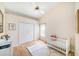 Lovely bedroom with a crib, closet, and soft rug on the wood floor at 13819 Stoneridge Dr, Hudson, FL 34669