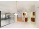 Open-concept kitchen with white tile flooring that adjoins dining area with hanging pendant light at 13819 Stoneridge Dr, Hudson, FL 34669