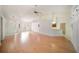 Spacious living room with light-colored hardwood floors, white walls and a ceiling fan at 13819 Stoneridge Dr, Hudson, FL 34669