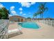 Community pool surrounded by lounge chairs and palm trees at 13819 Stoneridge Dr, Hudson, FL 34669