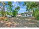 Home boasts a large yard with mature trees, perfect for outdoor activities at 1505 E 99Th Ave, Tampa, FL 33612
