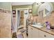 Updated bathroom with travertine tile and glass bowl sink at 1505 E 99Th Ave, Tampa, FL 33612