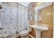 Bathroom includes shell-themed shower curtain and pedestal sink at 1505 E 99Th Ave, Tampa, FL 33612