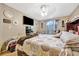 Comfortable bedroom features a ceiling fan, a flatscreen TV and lots of natural light at 1505 E 99Th Ave, Tampa, FL 33612
