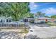 Charming single-story home featuring a fenced front yard, carport, and a cozy screened front porch at 1505 E 99Th Ave, Tampa, FL 33612