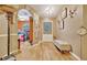 Well-lit hallway with wood floors, and an arched doorway leading to a dining area at 1505 E 99Th Ave, Tampa, FL 33612