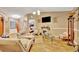 Bright living room with wood floors, neutral colors, and an open doorway to the bedroom at 1505 E 99Th Ave, Tampa, FL 33612