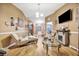 Inviting living room with a stone fireplace, wood floors, and seamless tv integration at 1505 E 99Th Ave, Tampa, FL 33612