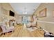 Cozy living room with laminate flooring, fireplace, and comfortable seating at 1505 E 99Th Ave, Tampa, FL 33612